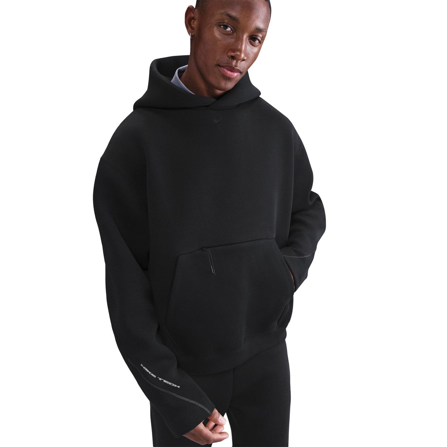 Person wearing a black hoodie on a white background