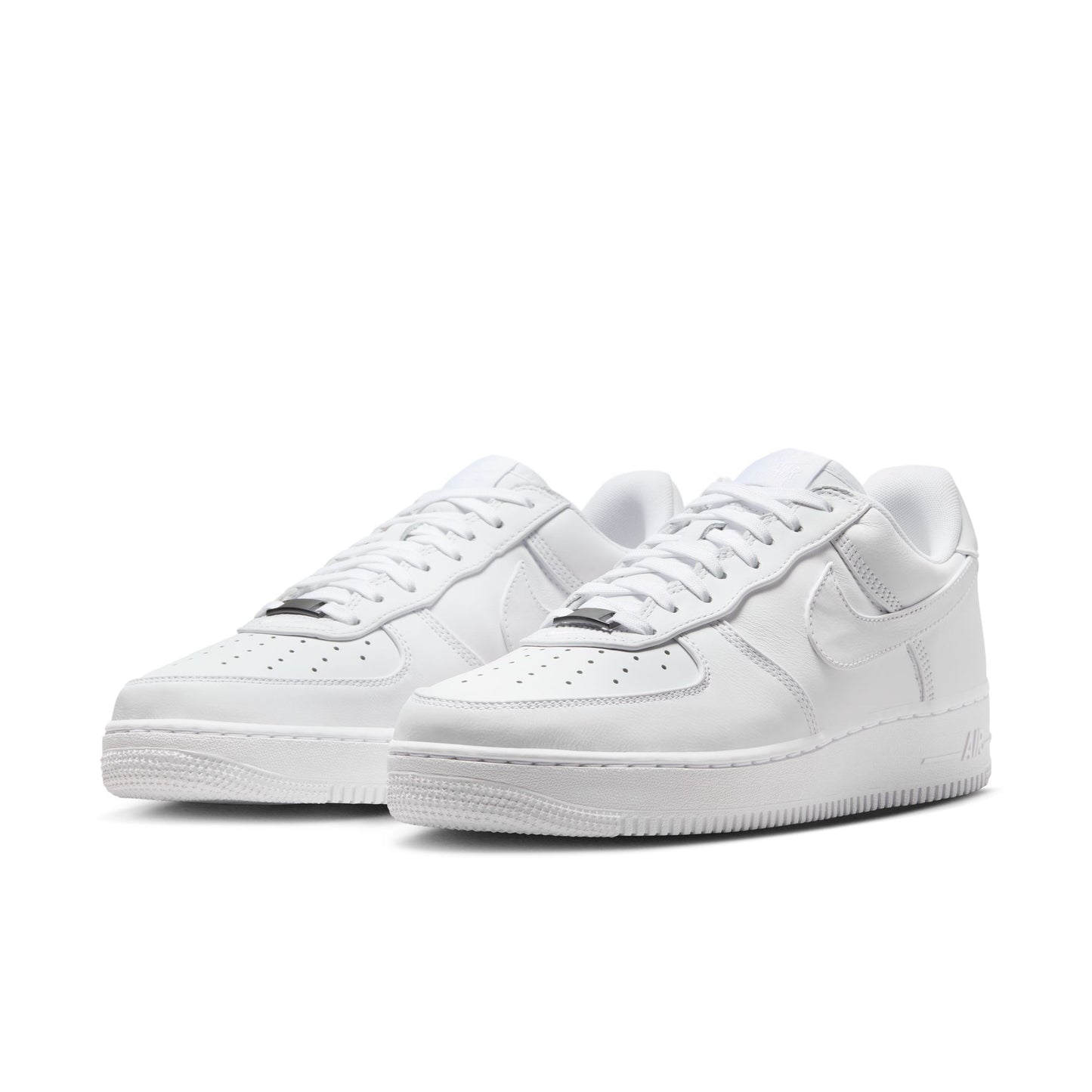 Pair of white sneakers on a white background
