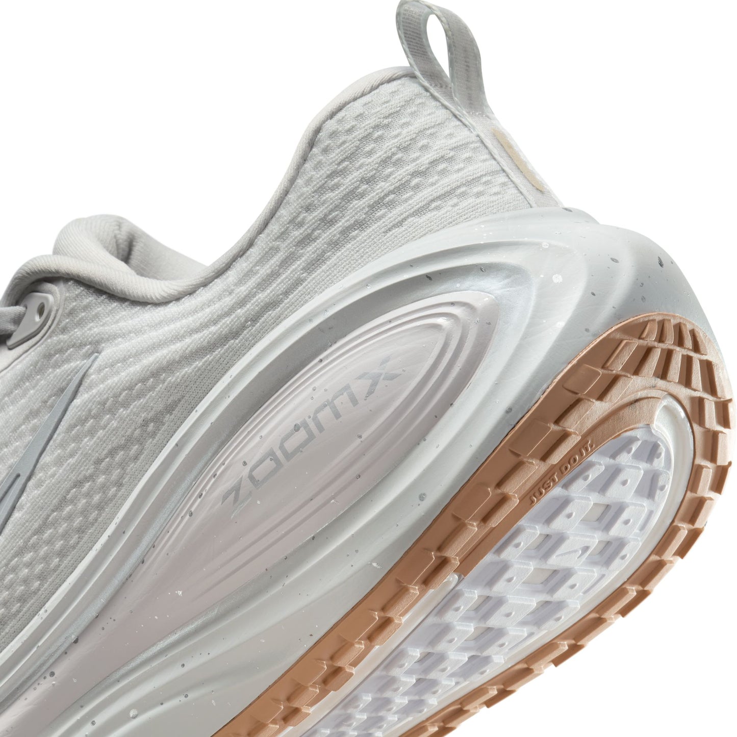 Close-up of a running shoe with 'Zoom' branding on a white background