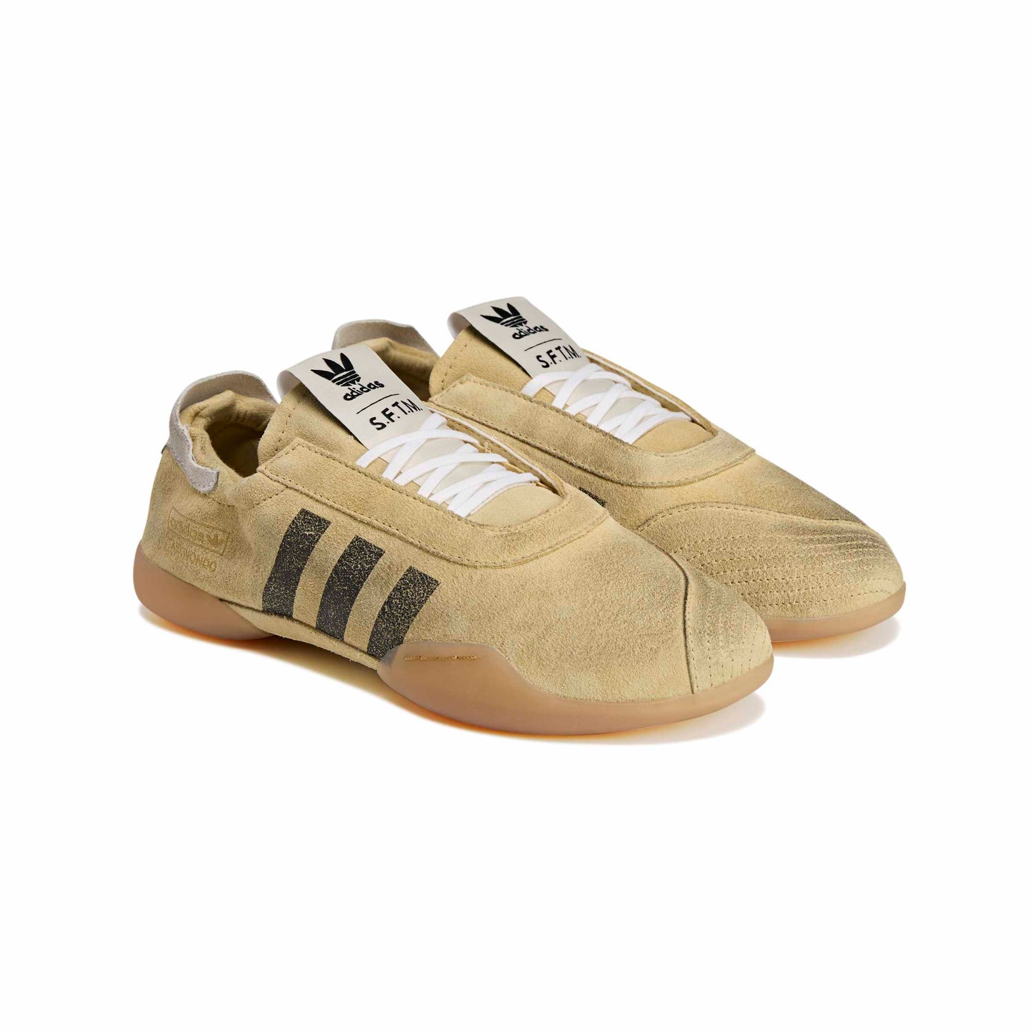 Distressed Beige sneakers with black stripes on a white background