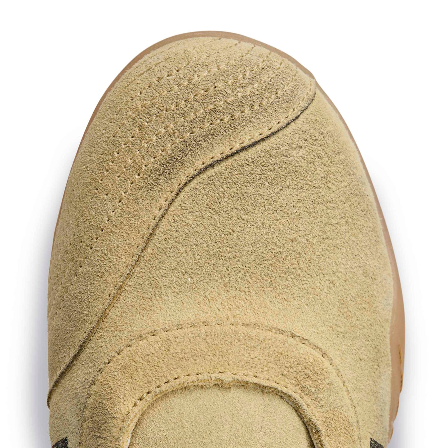 Close-up of a Distressed beige slip-on toe box on a white background