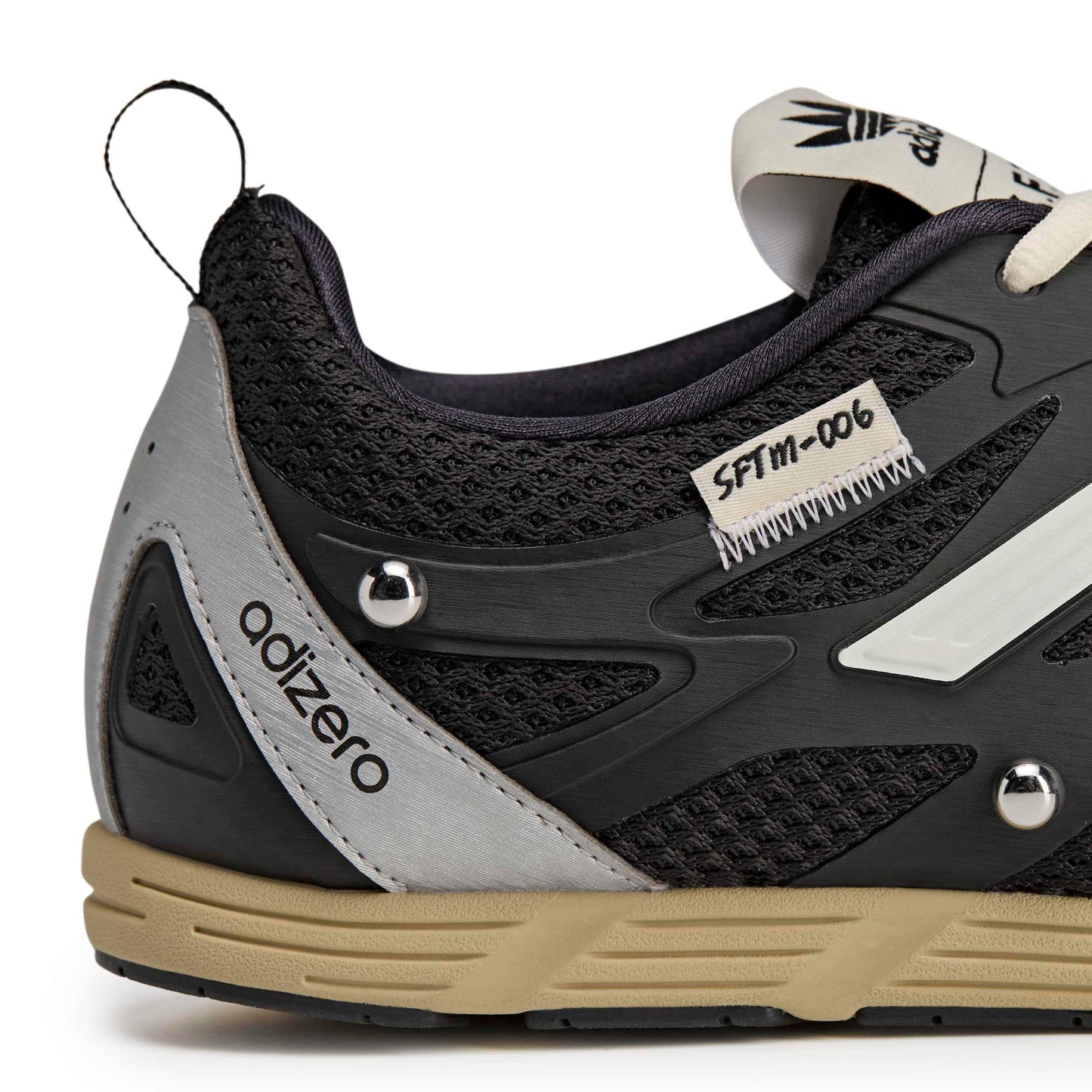 Black and gray athletic shoe with 'adizero' branding on a white background