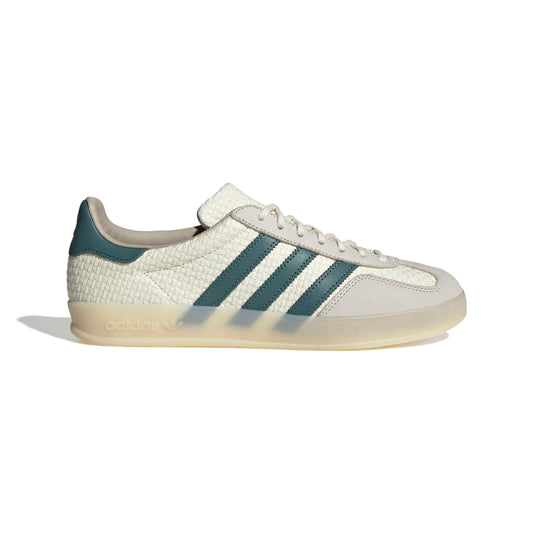 White Adidas sneaker with green stripes on a white background