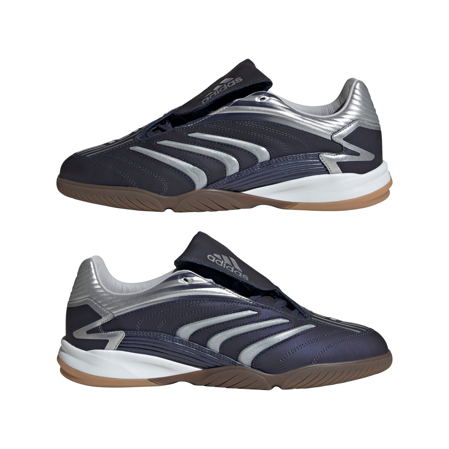 Pair of black and silver athletic shoes with brown soles on a white background