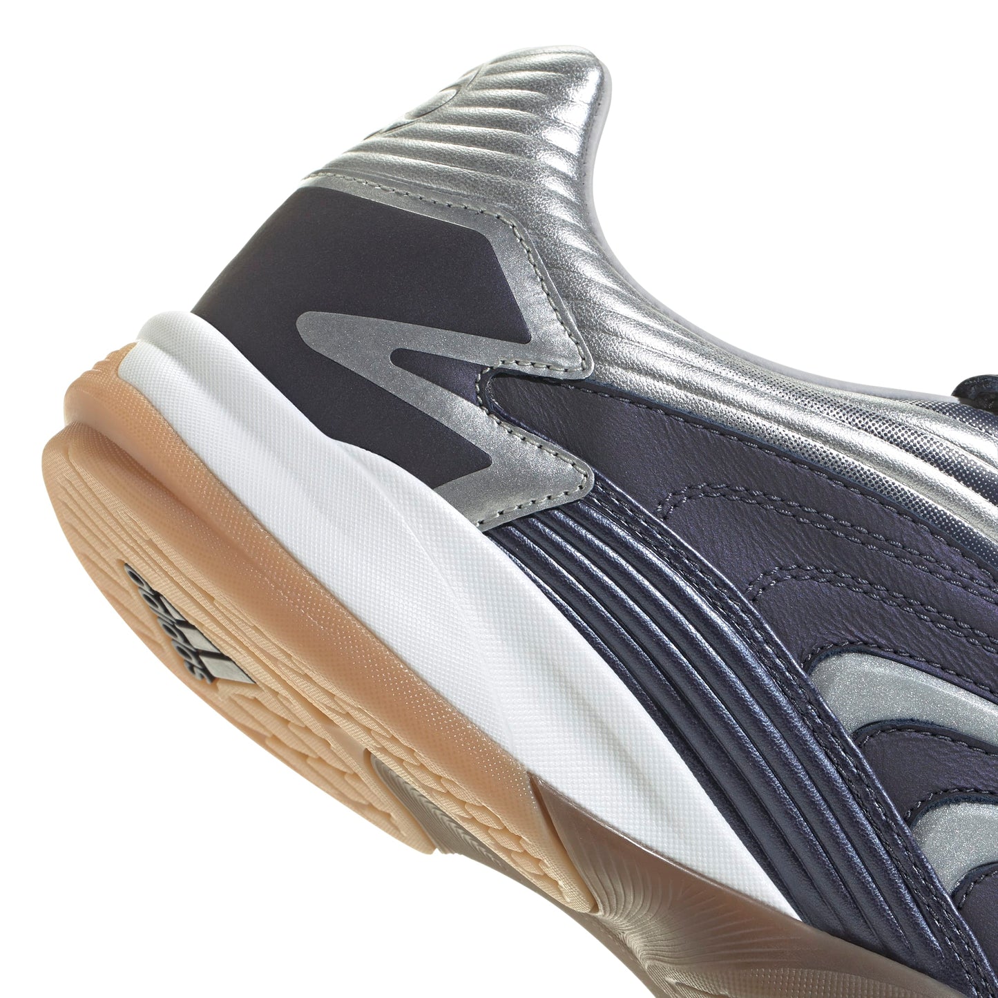 Close-up of a sports shoe with a focus on the sole and brand logo.