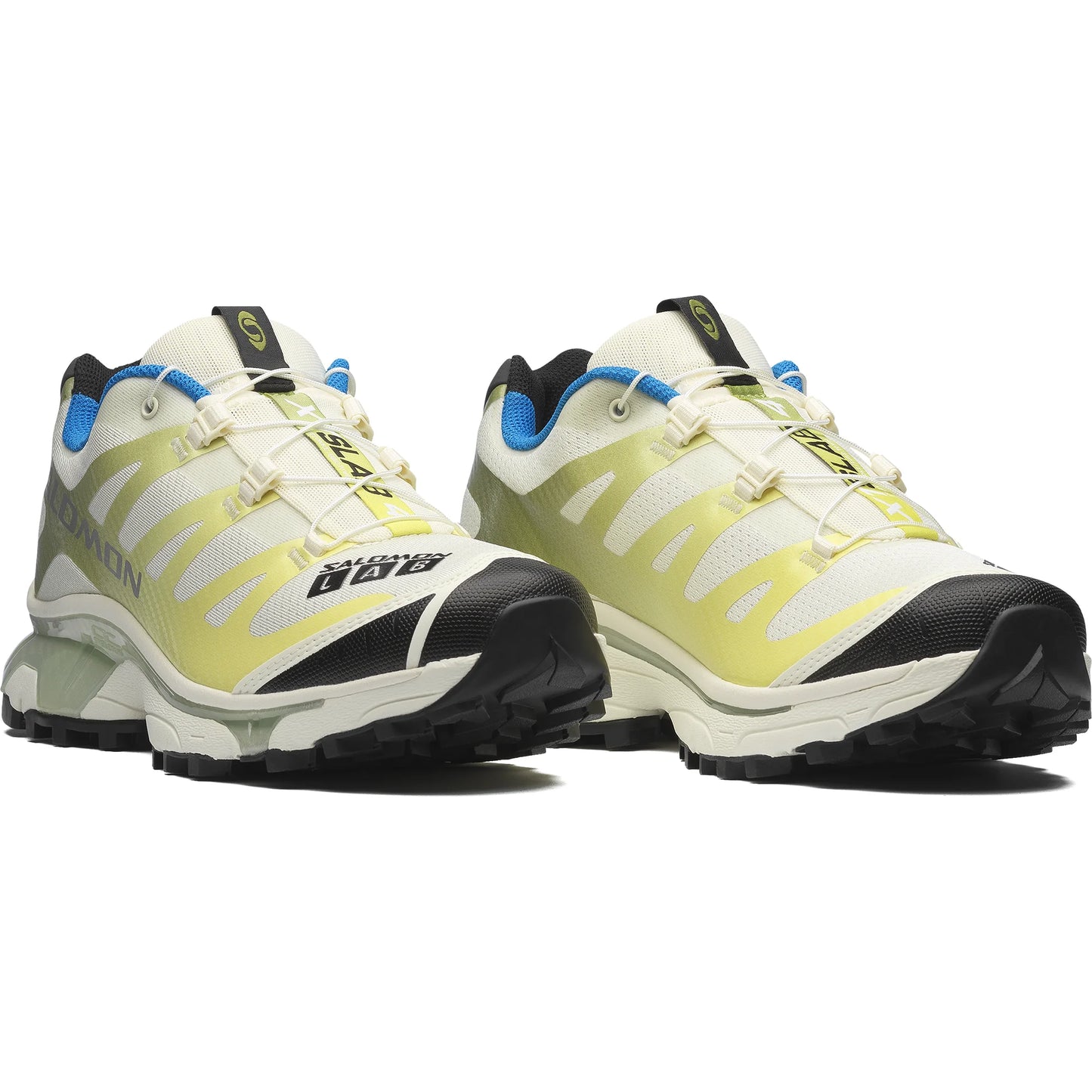 Pair of yellow and black Salomon hiking shoes on a white background