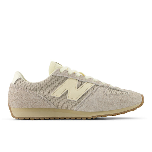 Beige sneaker with a prominent 'N' logo on a white background