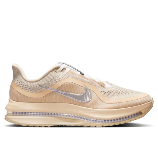 Beige running shoe with silver Nike logo on a white background