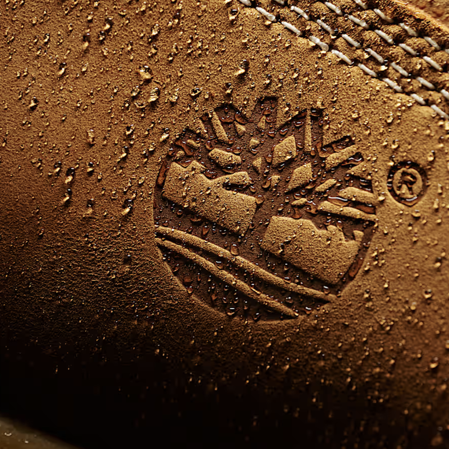 Close-up of a leather surface with a brand logo and text.