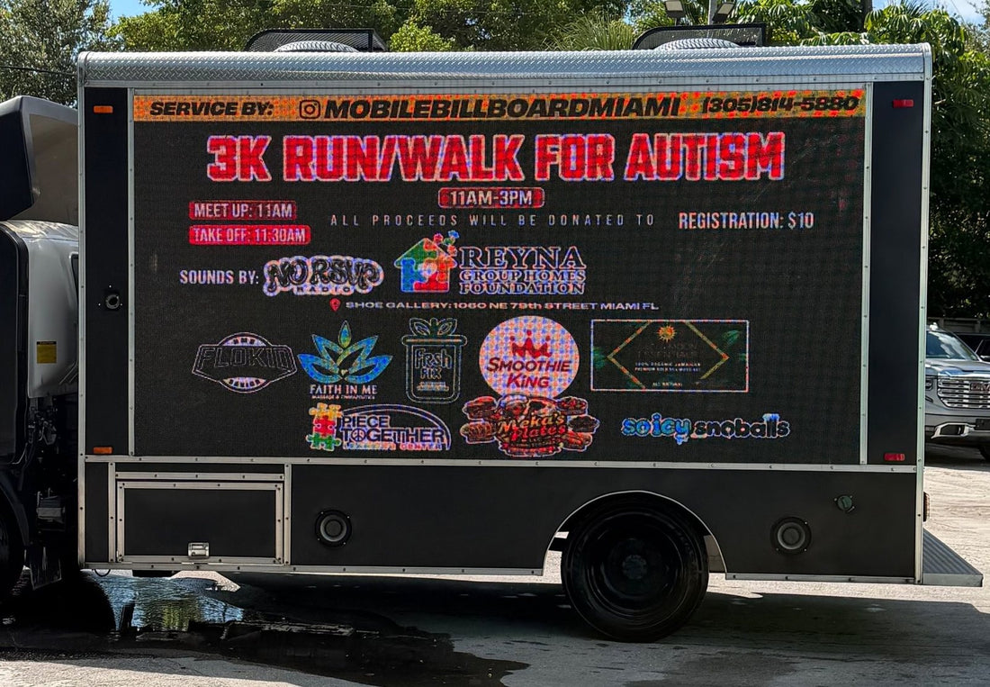 LED billboard truck parked outside Shoe Gallery showing the 3K Run/Walk for Autism lineup and partner logos