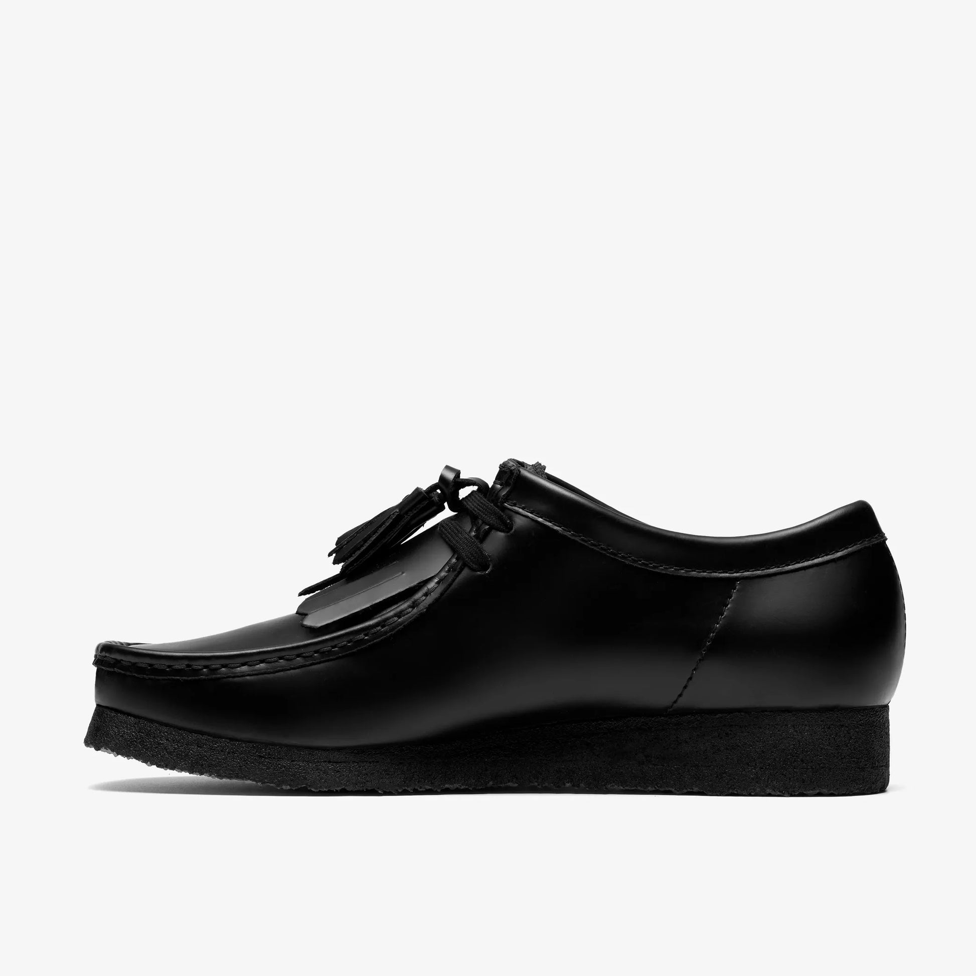 Black leather shoe with tassels on a white background
