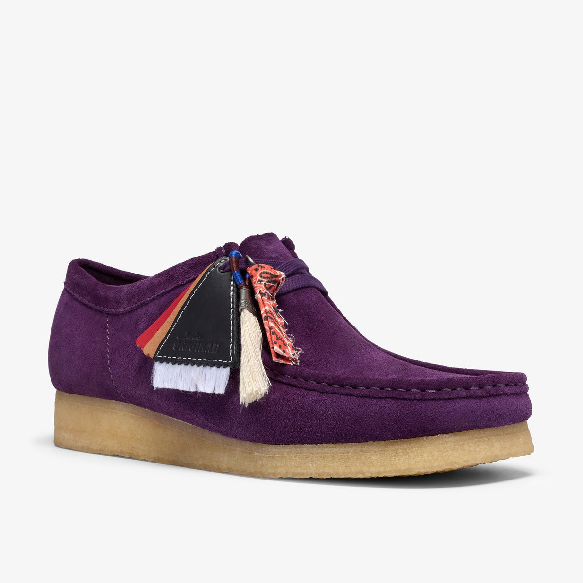 Clarks Wallabee in Damson Suede, front angle view with crepe sole, leather tags, tassel and bandana charm on laces