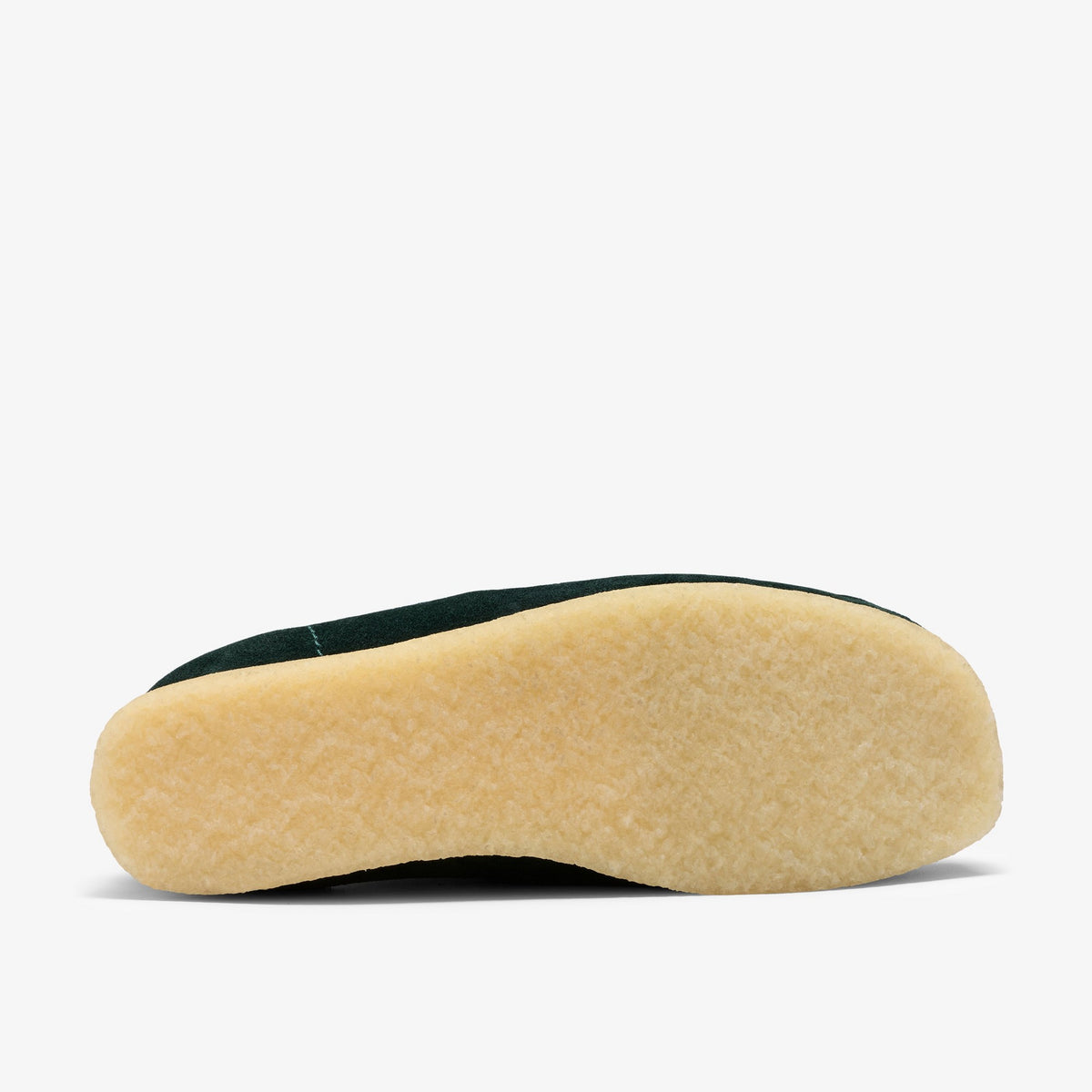Clarks Wallabee Boot sole view, natural crepe outsole with dark Forest Green suede upper visible at the edge