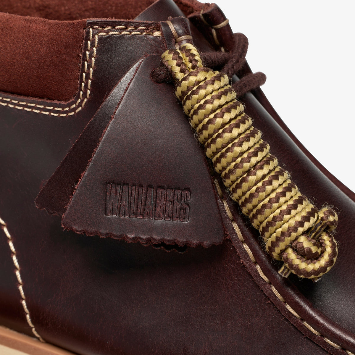 Clarks Walla Orkhon in British Tan, close-up of embossed Wallabees leather tag and tan and brown rope laces