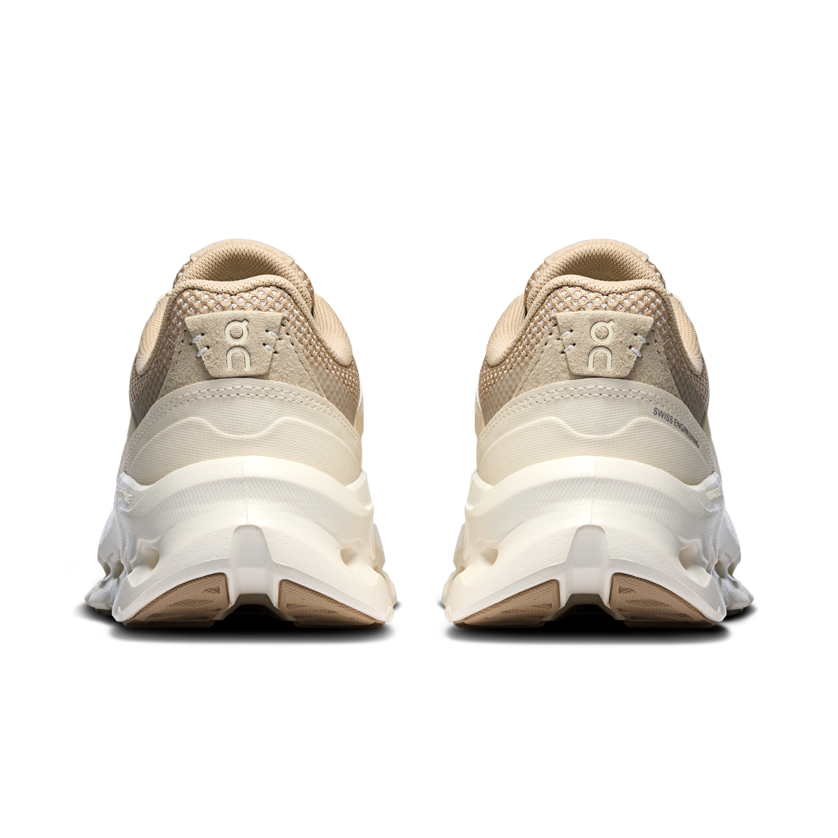 On Cloudtilt Arc in Grain / Ivory, back view of pair showing suede heel tabs with On logo and ivory cushioned soles
