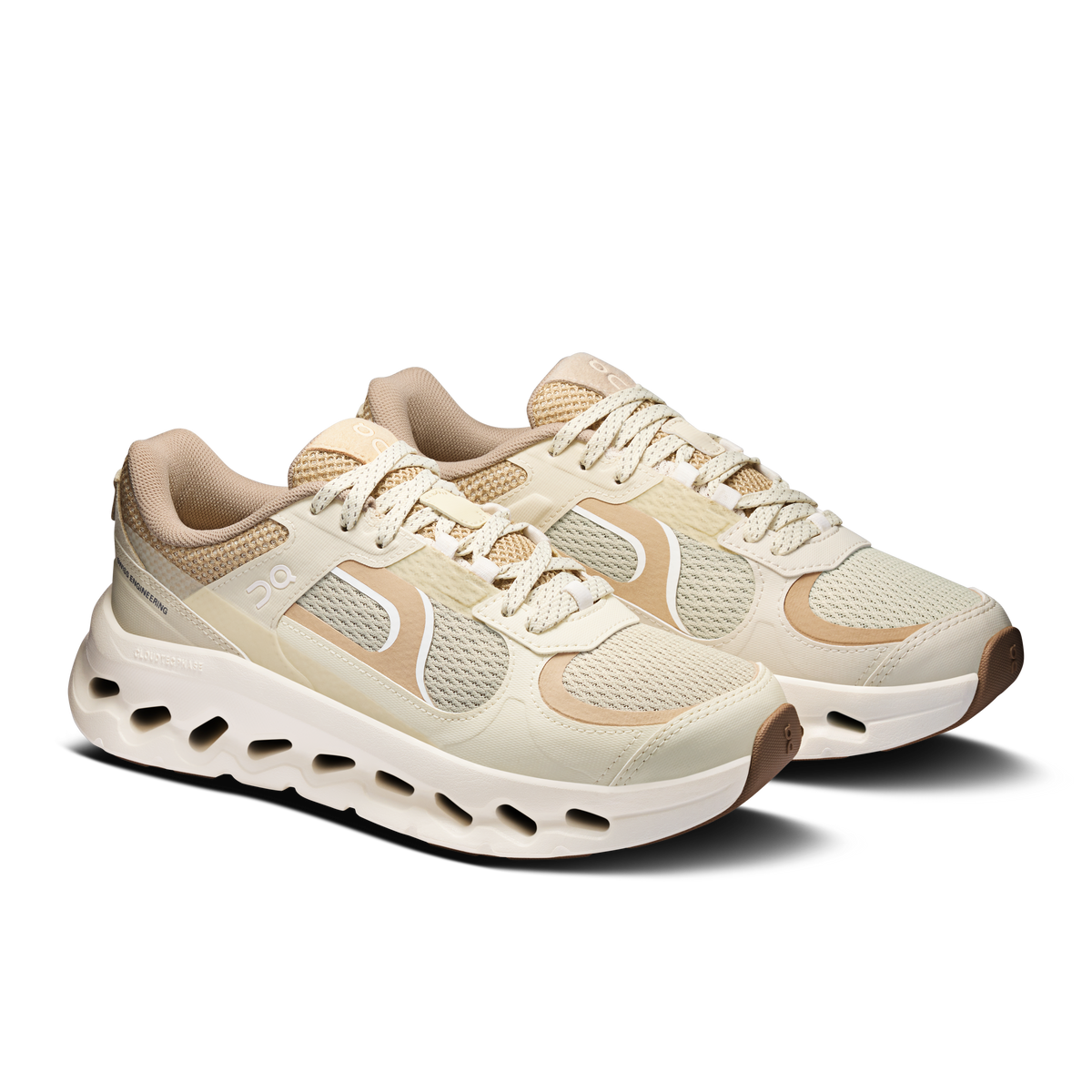 On Cloudtilt Arc in Grain / Ivory, pair at angle showing tan mesh, ivory overlays and cutout CloudTec sole