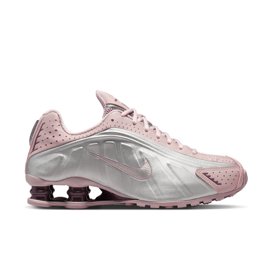 Pink and silver sneaker with Nike logo on a white background