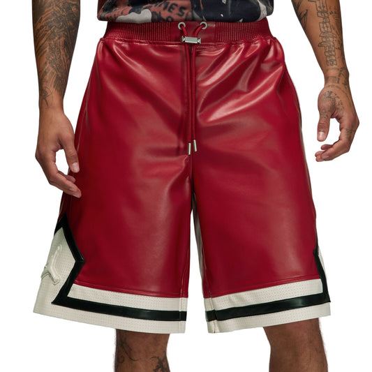 Red leather shorts with white and black trim on a white background