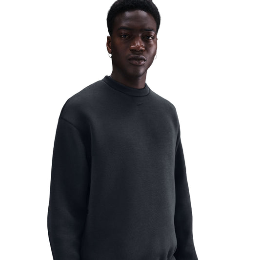 Person wearing a black sweater on a white background