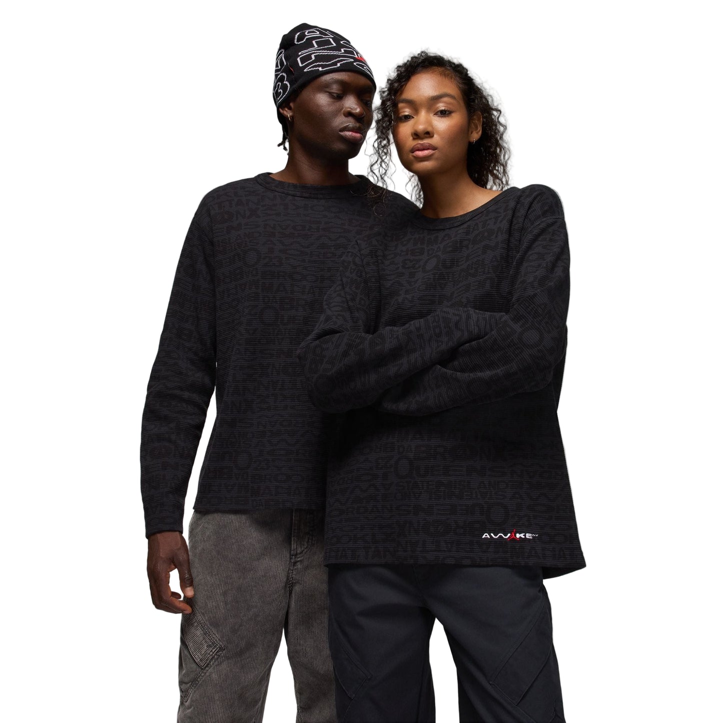 Two people wearing matching black thermals against a white background