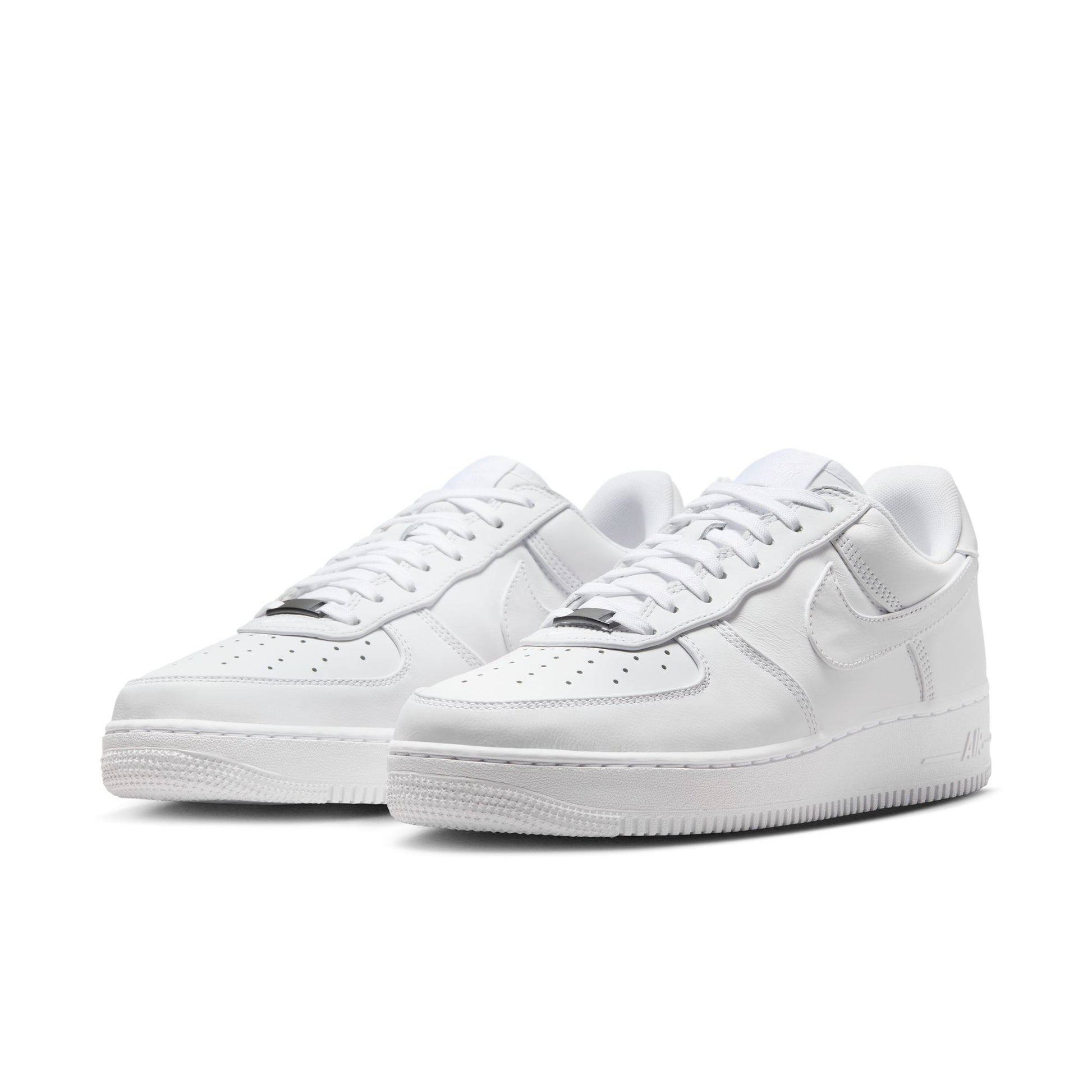 Pair of white sneakers on a white background