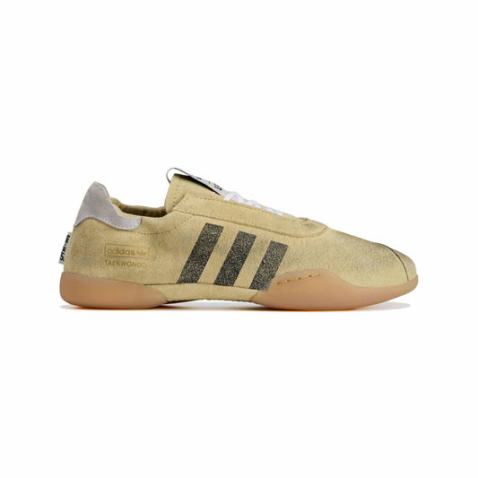Distressed Beige sneaker with black stripes on a white background