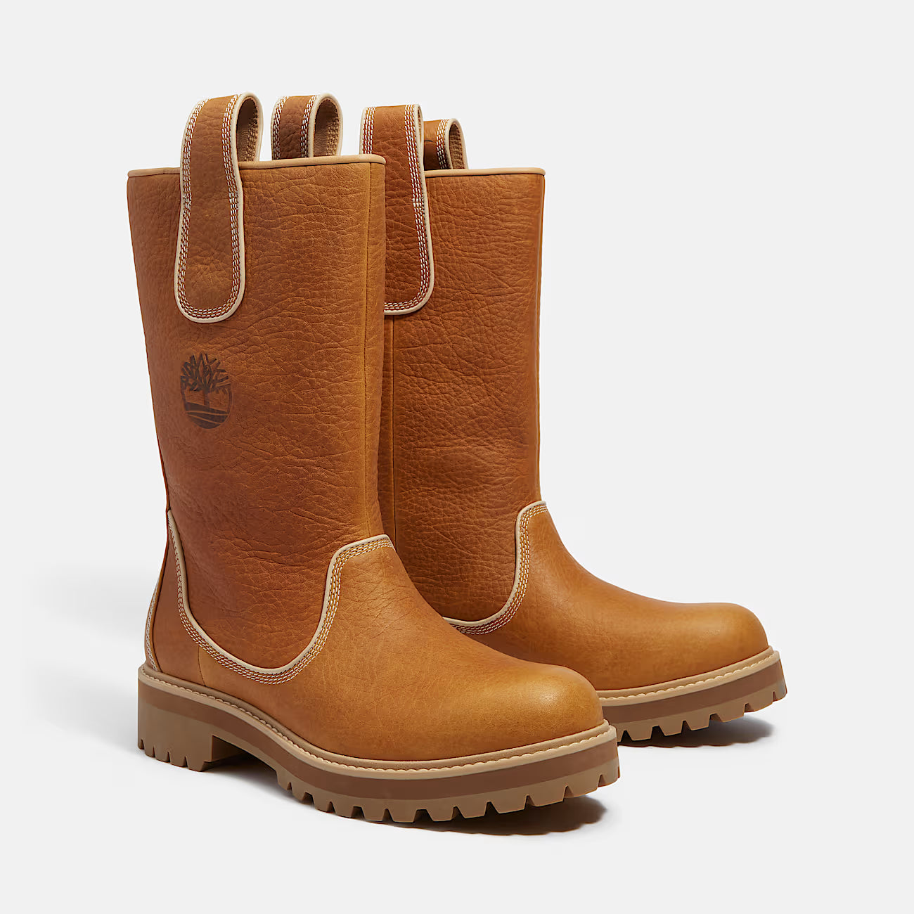 Pair of brown leather boots with a visible brand logo on a white background