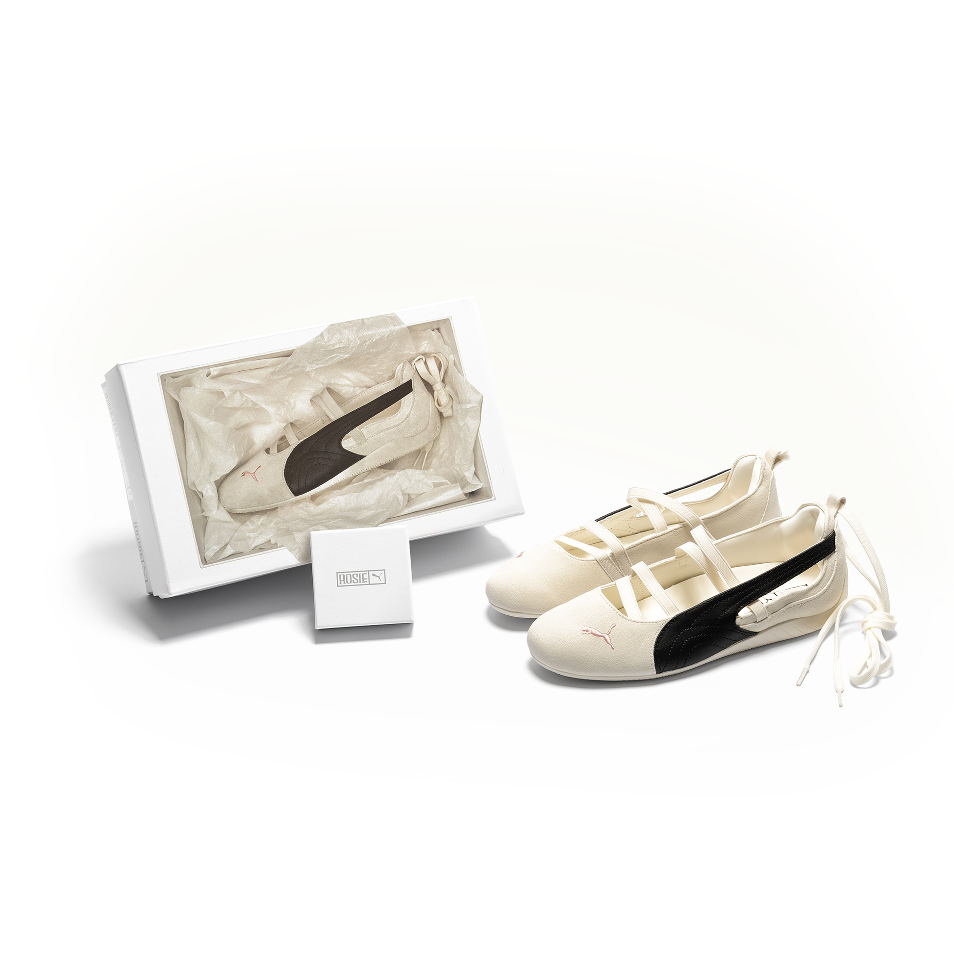 Natural White and black Puma sneaker with packaging on a white background
