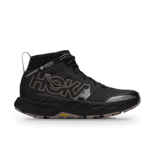 HOKA Speedgoat 7 Hike GTX side view in Black/Pebble Grey, large outlined HOKA logo, GORE-TEX tag, Vibram sole