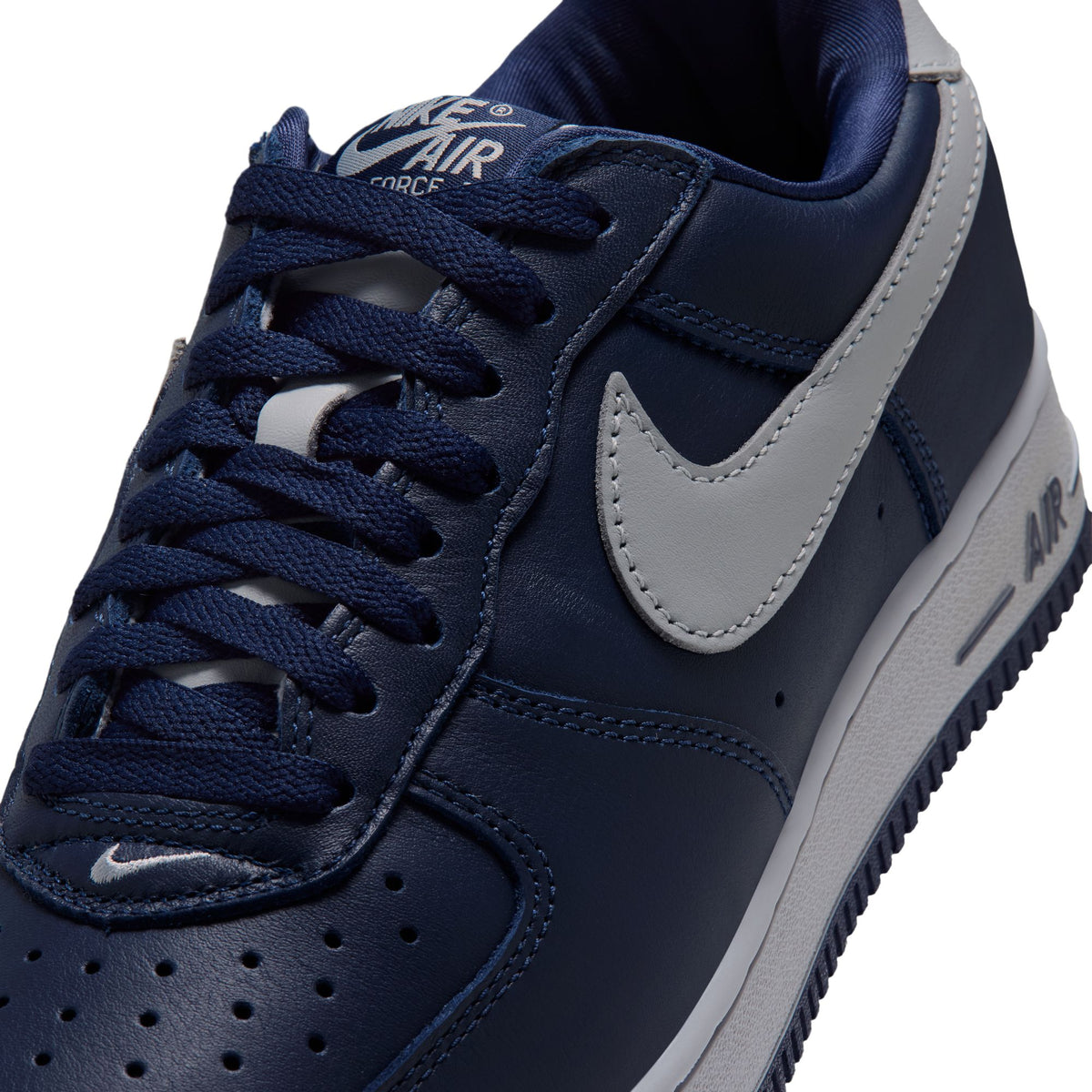 Nike Air Force 1 '01 close-up of College Navy leather upper with Lt Smoke Grey Swoosh, laces and tongue label