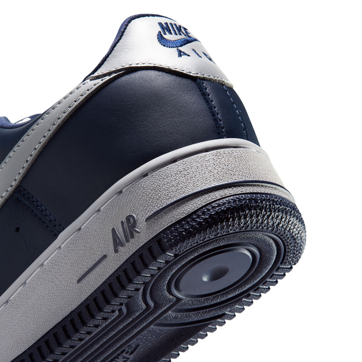 Nike Air Force 1 '01 heel close-up: College Navy leather, Lt Smoke Grey midsole with AIR logo, navy outsole