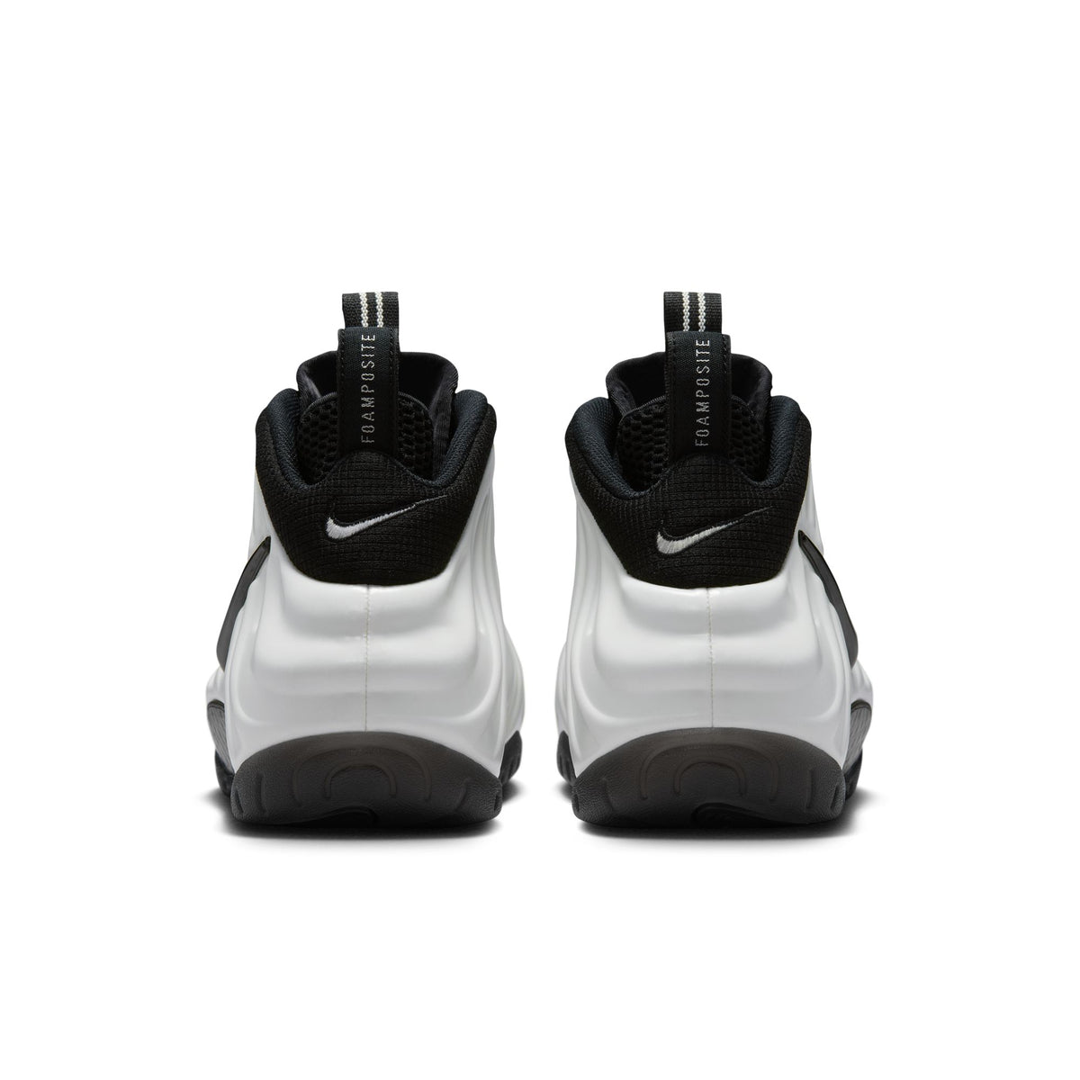 Nike Air Foamposite Pro back view of pair in Summit White/Black, black collars, Swoosh logos and Foamposite pull tabs