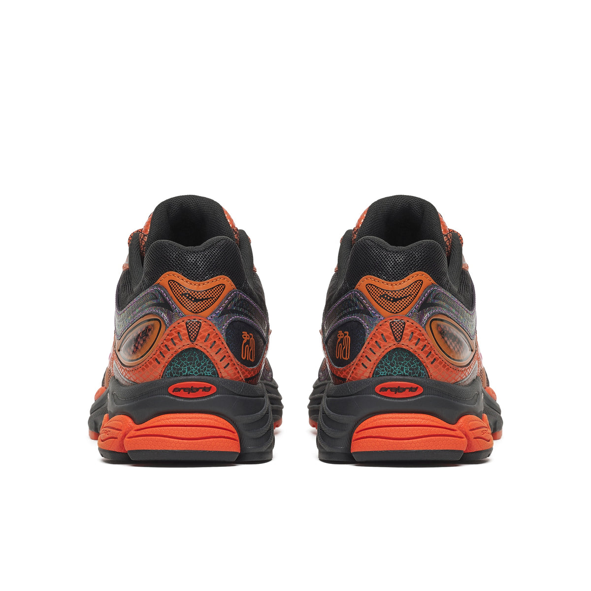 Saucony ProGrid Omni 9 Copper Glow pair, back view of orange snake-texture heels, teal crackle accents, black soles