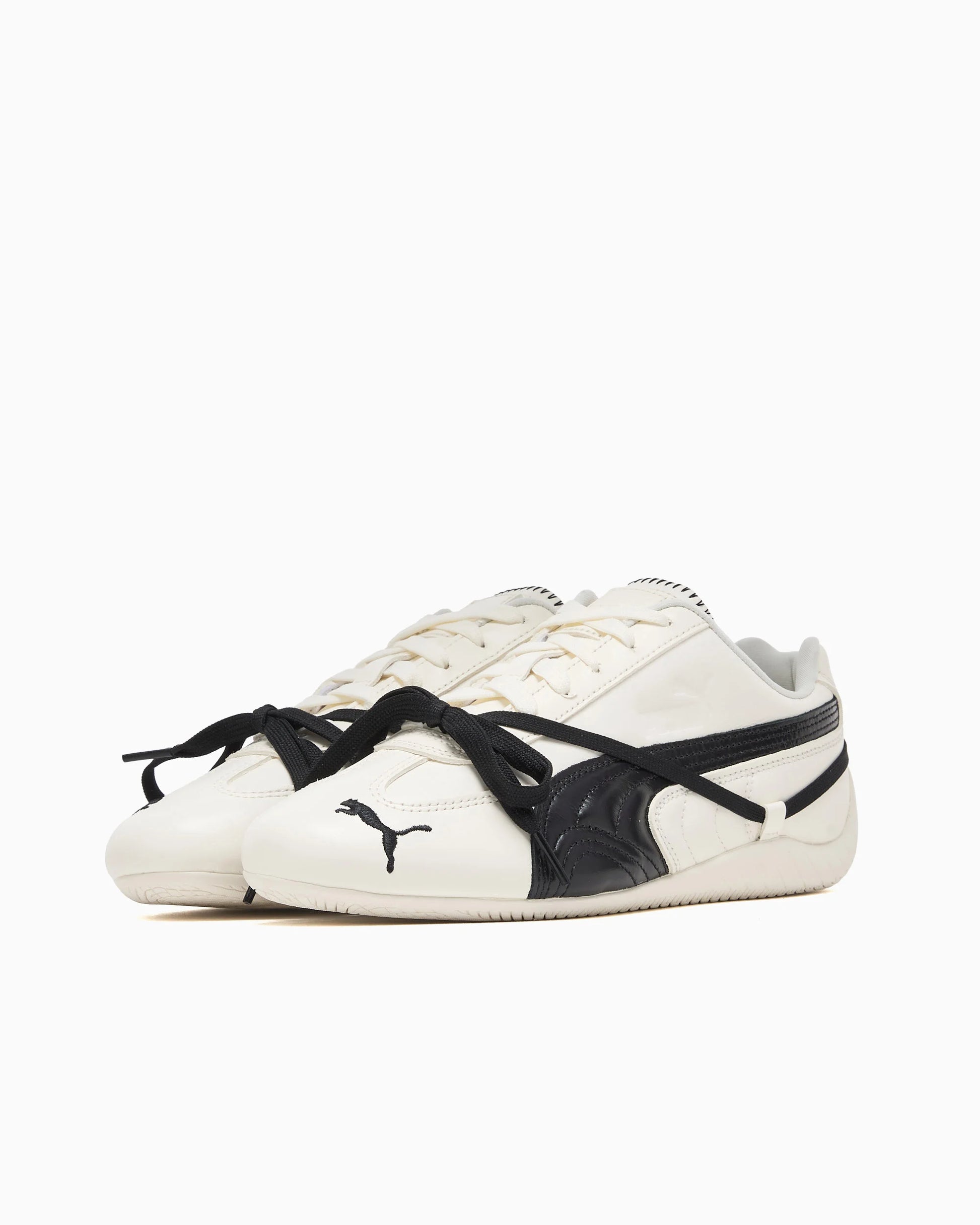 White Puma sneakers with black accents on a white background