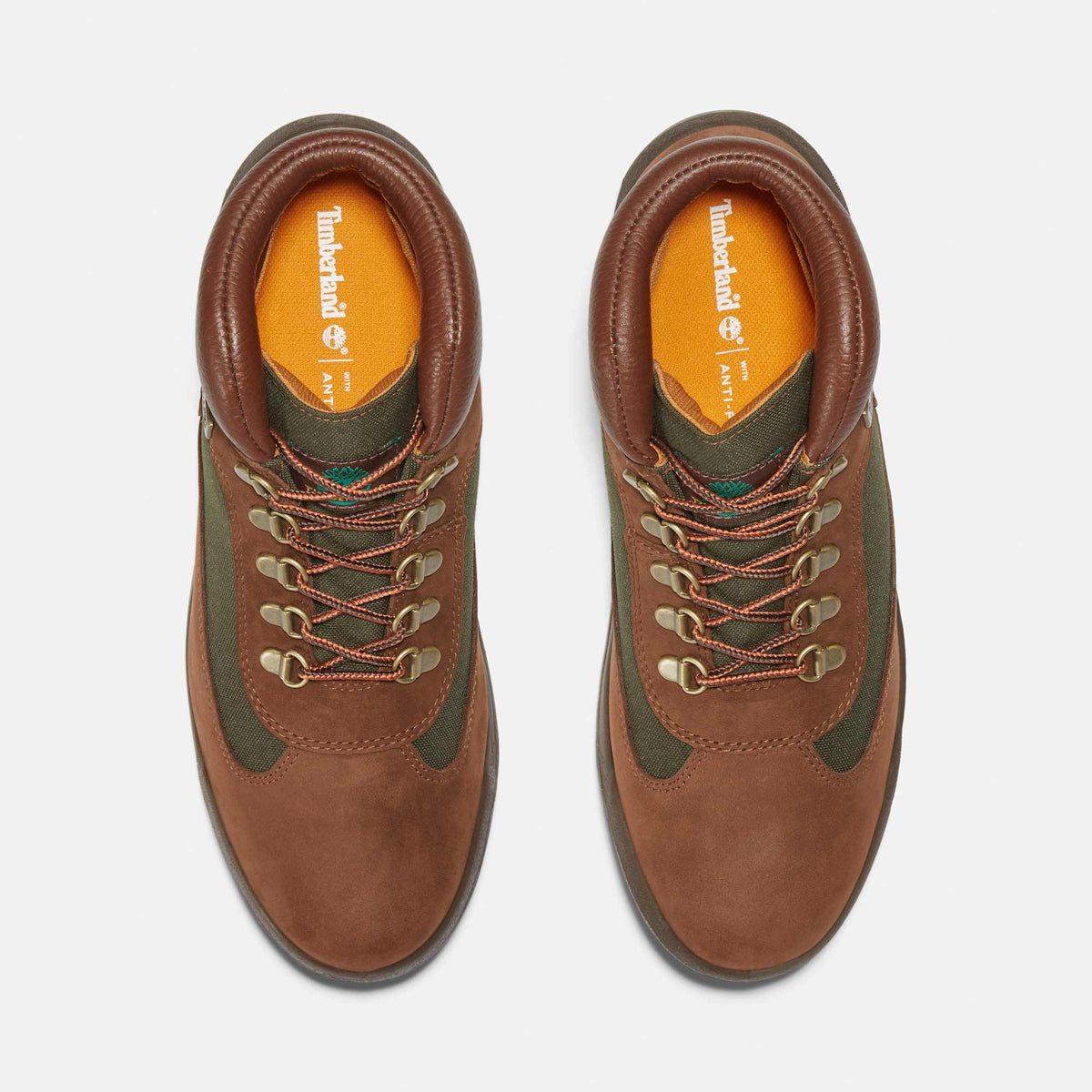 Timberland Field Boot pair, top view: dark brown nubuck, olive green canvas panels, orange laces, orange insoles
